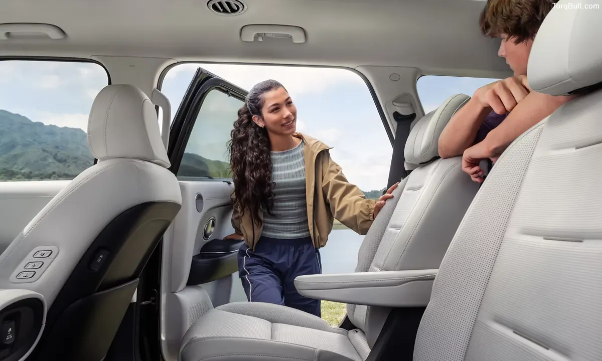 A young girl is sitting inside a Hyundai Palisade