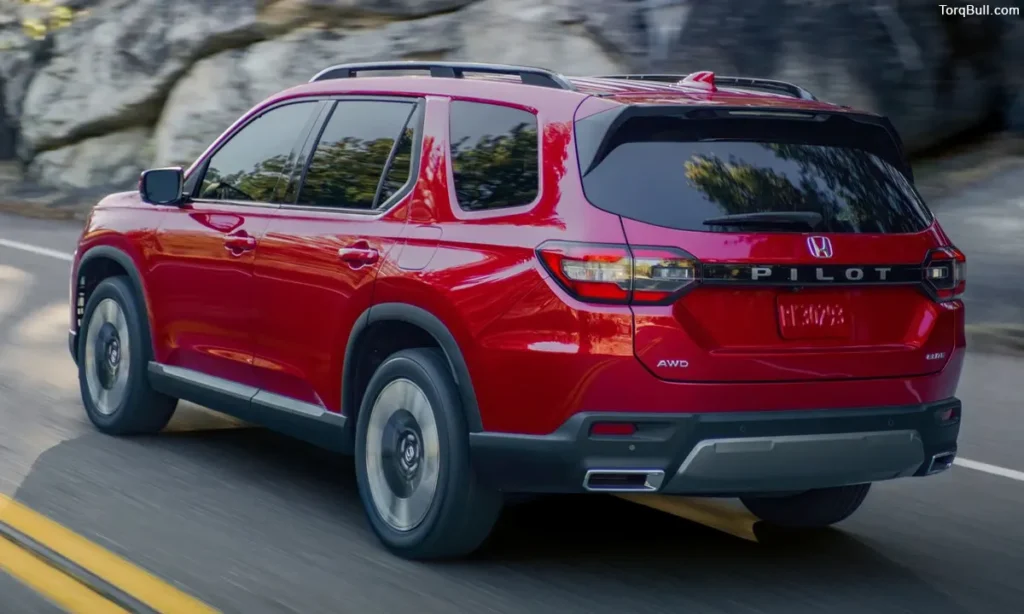 Red Honda Pilot driving on mountain rear view 4598067
