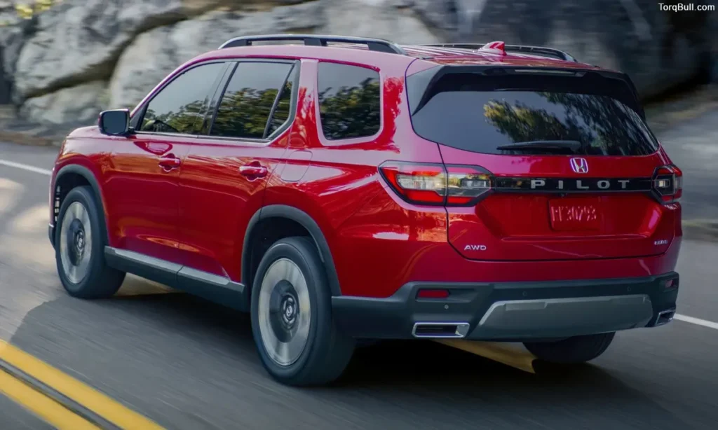 Honda Pilot driving on road rear view 349058