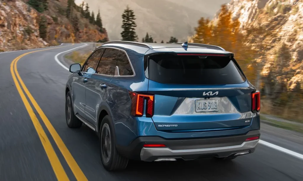 Kia Sorento back view driving on mountain
