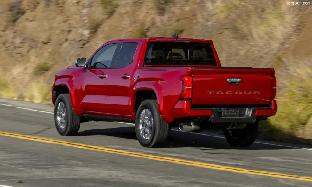 Red Toyota Tacoma rear view on the road 3248975