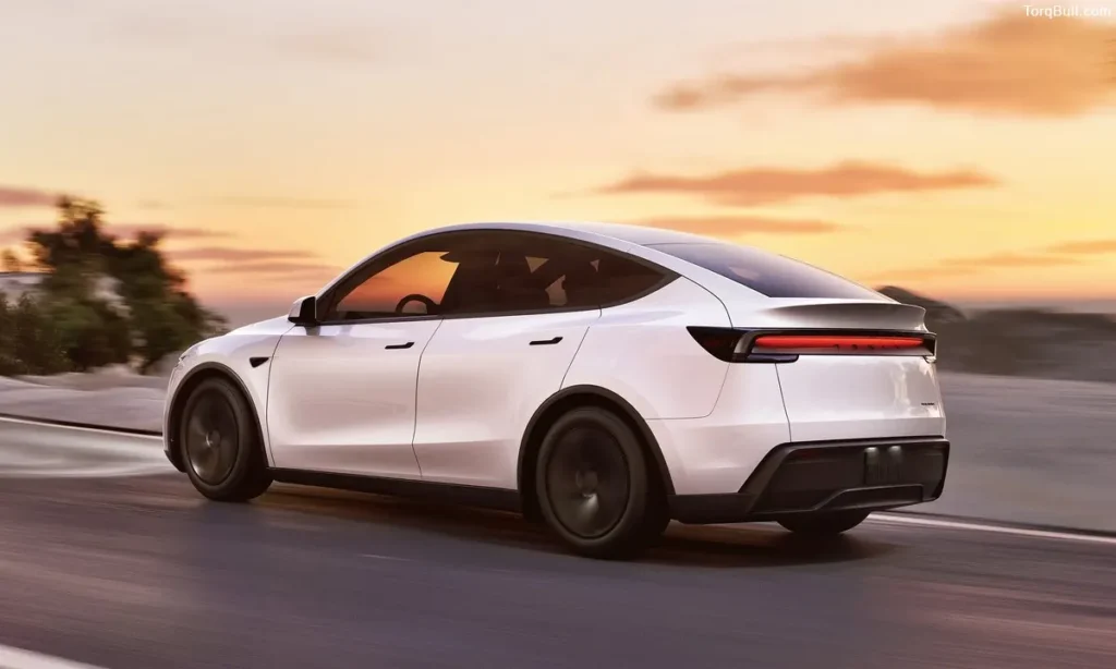 Tesla Model Y rear view on road in the sunset