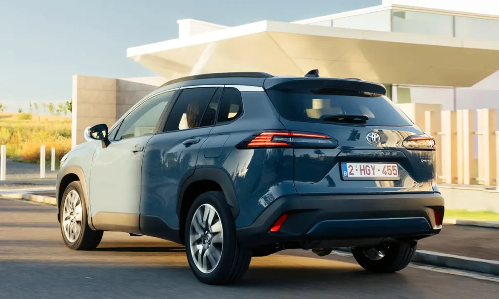 Toyota Corolla Cross on road rear view in a society