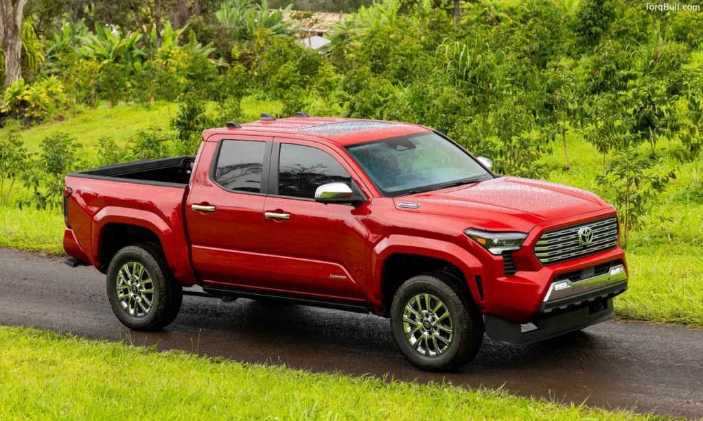 Red Toyota Tacoma running on rainy road